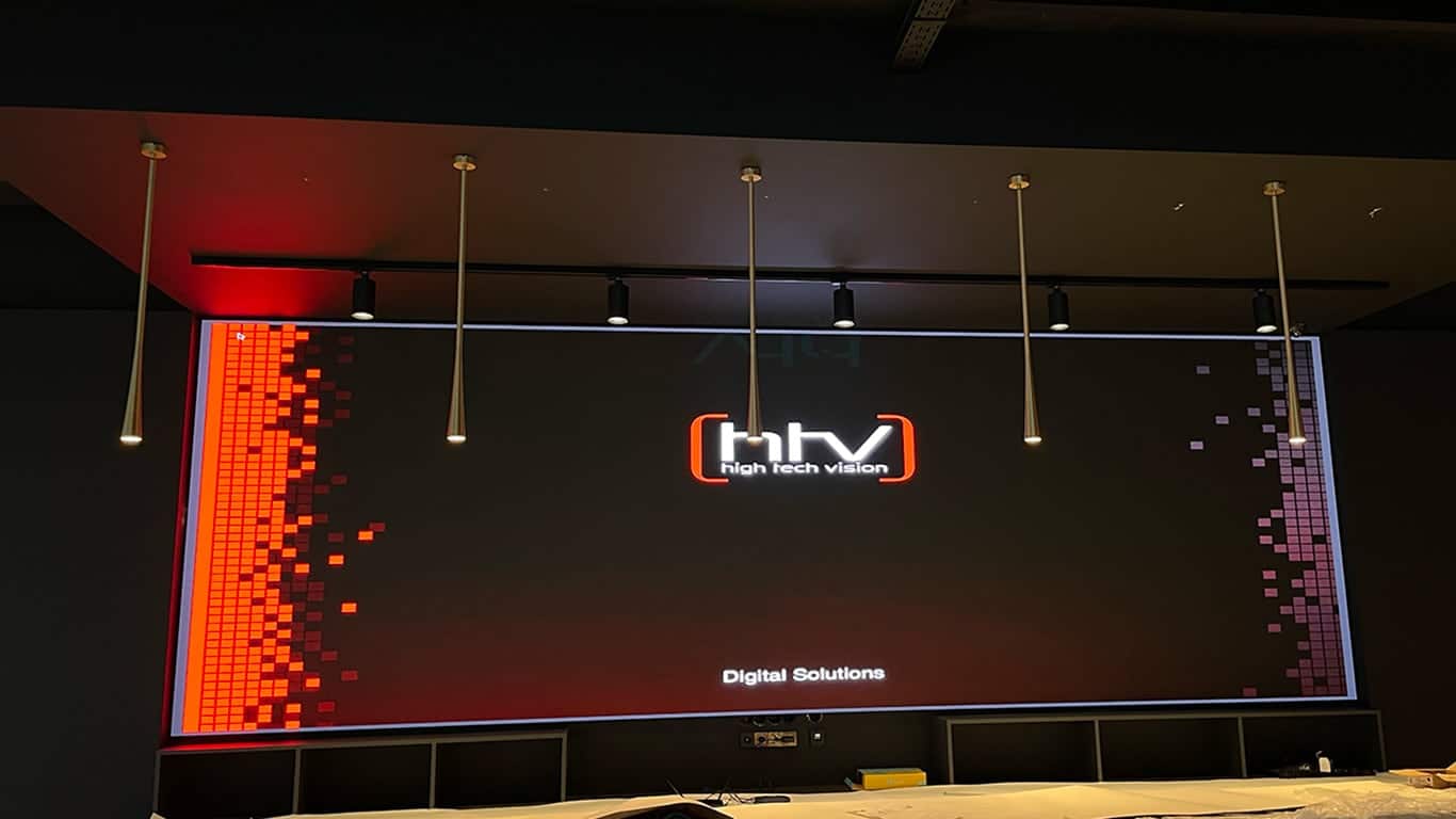 a large screen with lights from the ceiling