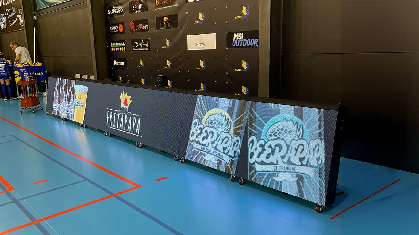 a large screen with a logo on it