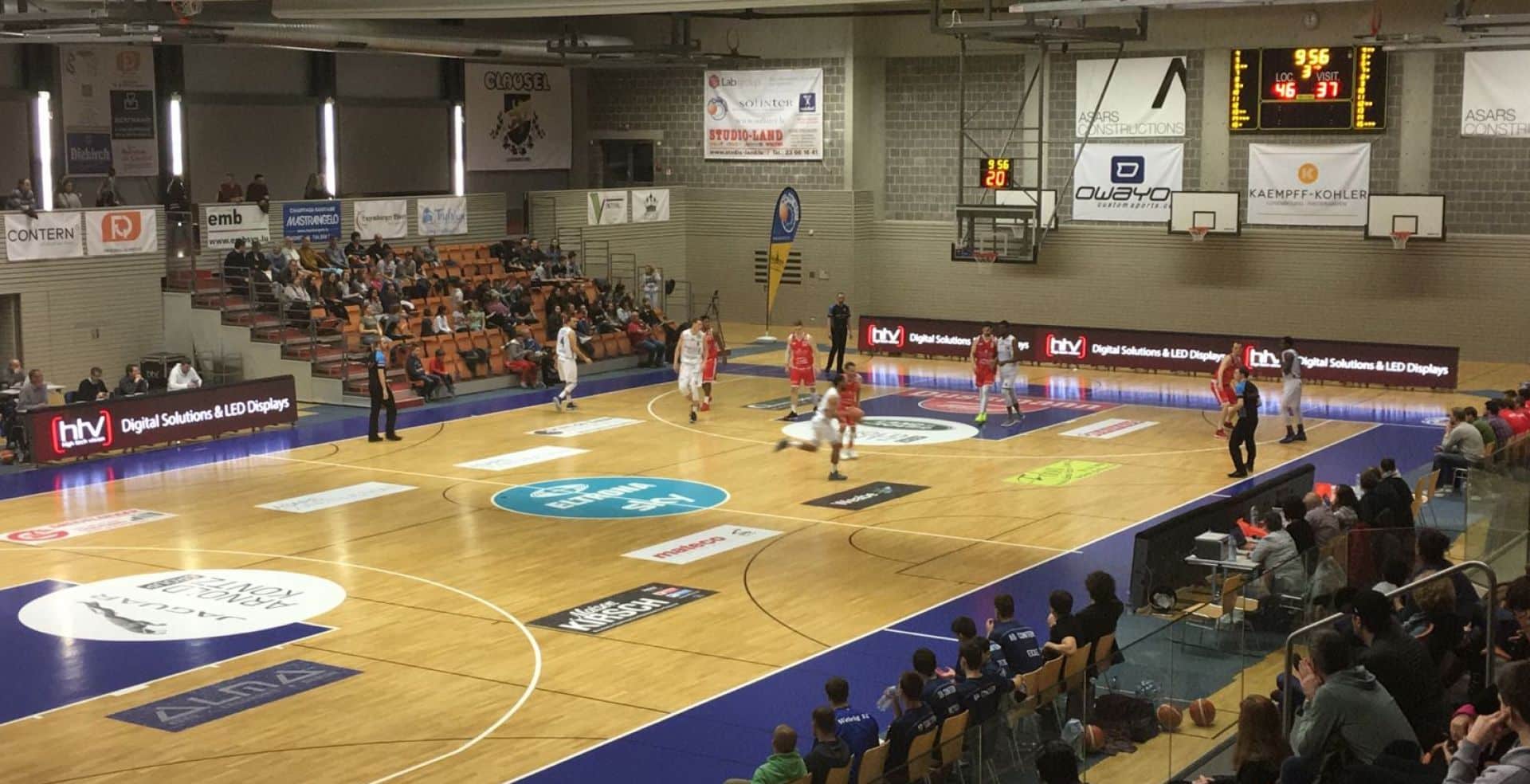 a basketball court with people watching