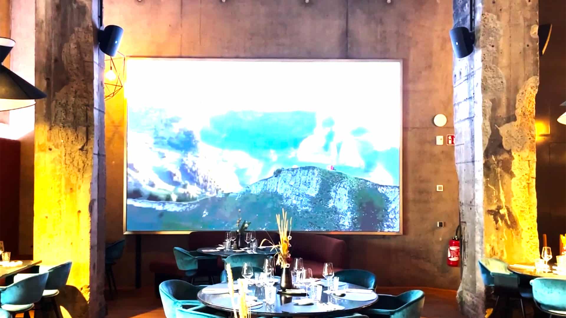 a table with chairs and a large screen