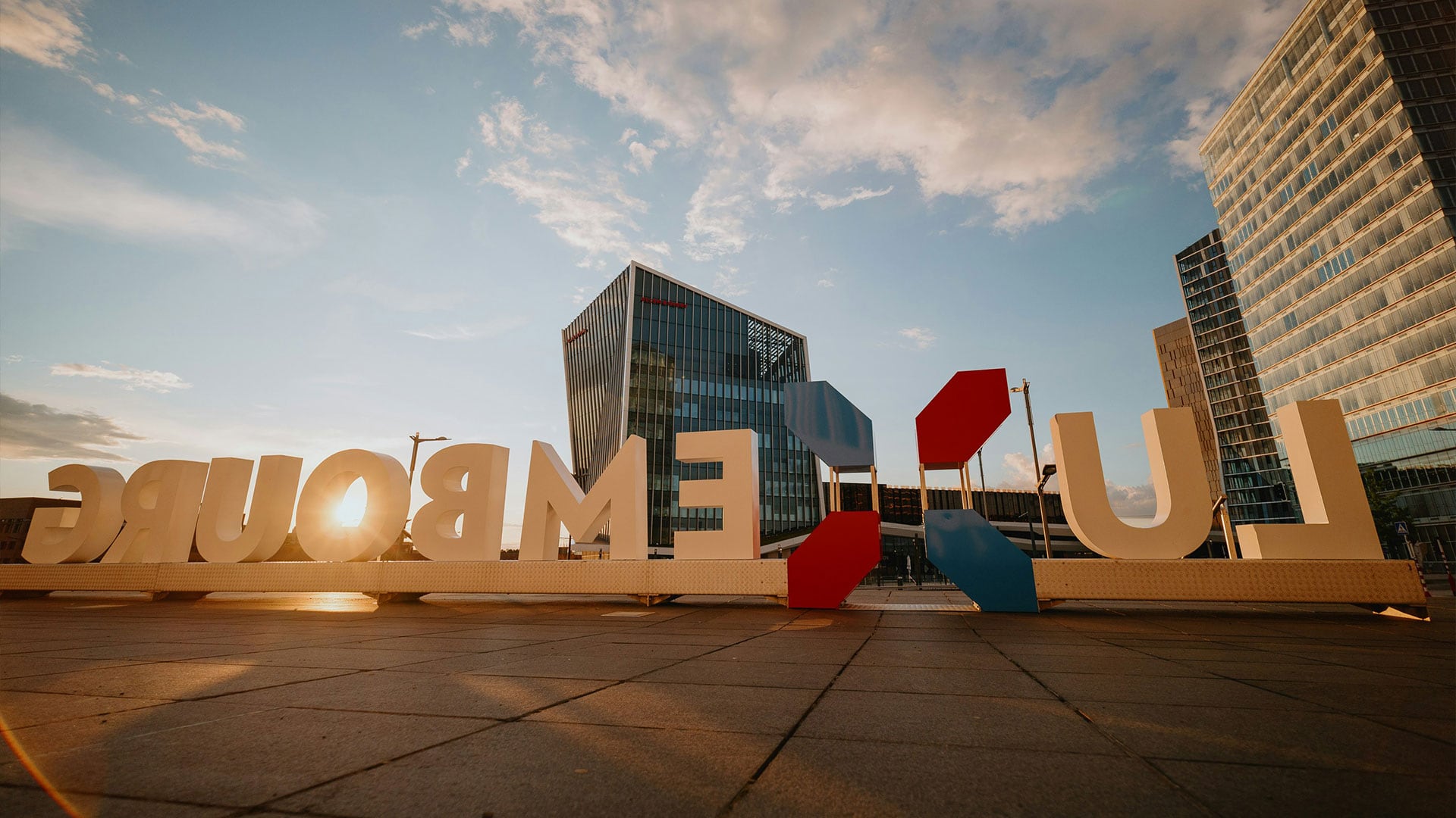 a large sign with a building in the background